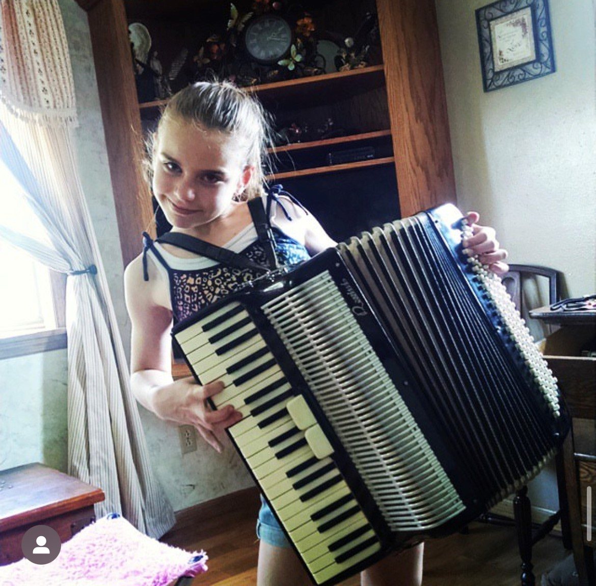 Abbi holding an accordion
