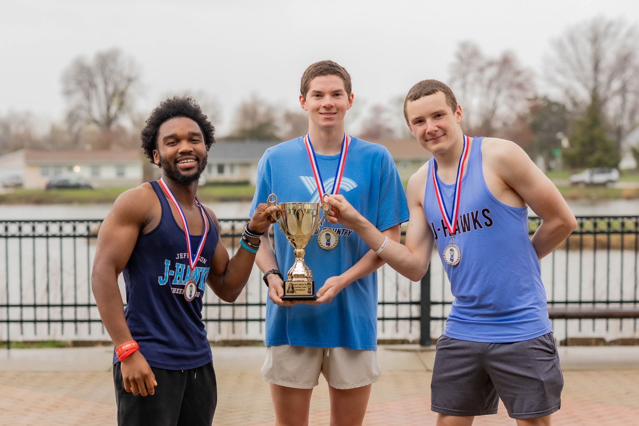 Hope in Motion 5K participants with medals and the Hope Cup